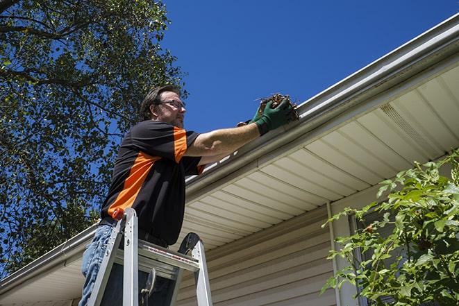 a gutter repair specialist fixing a leaky rain gutter in Belvedere